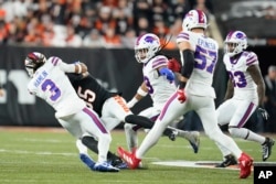 Cincinnati Bengals wide receiver Tee Higgins (85) collides with Buffalo Bills safety Damar Hamlin (3) during the first half of an NFL football game, Monday, Jan. 2, 2023, in Cincinnati. (AP Photo/Joshua A. Bickel)