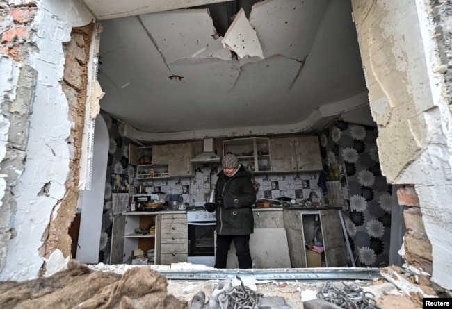 Liubov Onyschenko looks around her house, which was heavily damaged by a Russian missile strike, amid Russia's attack on Ukraine, in the village of Kupriianivka, Zaporizhzhia region, Ukraine, Dec. 7, 2022.