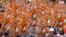 FILE - In this file photo taken on February 28, 2021 protesters hold posters with the image of detained civilian leader Aung San Suu Kyi during a demonstration against the military coup in Naypyidaw, Myanmar.