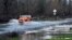 A vehicle drives on a flooded road in Sebastopol, California, Jan. 5, 2023. 