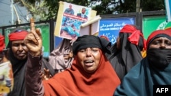 FILE - Mothers of missing Somali soldiers training in Eritrea gesture during a protest against the Somali government to provide them with more information, in Mogadishu, on June 10, 2021. 