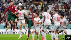 Portugal's Cristiano Ronaldo, left, and Switzerland's Ricardo Rodriguez go for a header during the World Cup round of 16 soccer match at the Lusail Stadium in Lusail, Qatar, Dec. 6, 2022.