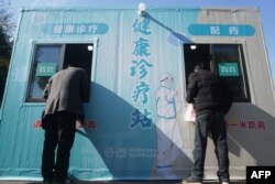 People visit a makeshift clinic transformed from a COVID-19 testing booth in Hangzhou, in China's eastern Zhejiang province, Dec. 20, 2022.