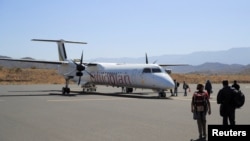 FILE - Passengers board the Ethiopian Airlines plane at the Lalibela Airport in Lalibela town of the Amhara Region, Ethiopia, Jan. 27, 2022.