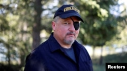 FILE - Oath Keepers militia founder Stewart Rhodes poses during an interview in Eureka, Montana, June 20, 2016.