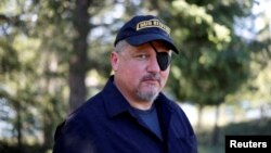 FILE - Oath Keepers militia founder Stewart Rhodes poses during an interview in Eureka, Montana, June 20, 2016. 