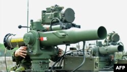 FILE - Taiwanese soldiers man mobile launchers of the U.S.-made TOW anti-tank missiles during a drill in Taoyuan county, April 18, 2012.