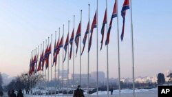 National flags are seen half-staffed on the occasion of the 11th anniversary of the death of Chairman Kim Jong Il in Pyongyang, North Korea, on Dec. 17, 2022.