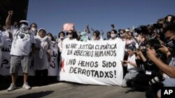 FILE - Protesters, wearing white in support of political prisoners as well as human rights defenders and environmental activists, stage in a demonstration at the COP27 U.N. Climate Summit, Nov. 10, 2022, in Sharm el-Sheikh, Egypt. 