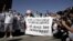 FILE - Protesters, wearing white in support of political prisoners as well as human rights defenders and environmental activists, stage in a demonstration at the COP27 U.N. Climate Summit, Nov. 10, 2022, in Sharm el-Sheikh, Egypt. 
