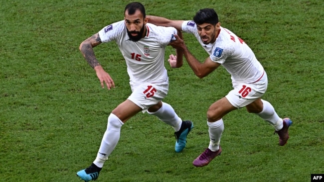 Iran's Roozbeh Cheshmi, left, celebrates scoring his team's first goal during its 2022 World Cup Group B soccer match against Wales at the Ahmad Bin Ali Stadium in Al-Rayyan, Nov. 25, 2022.