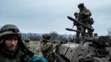 Servicemen of the Carpathian Sich Battalion are seen near an Armored Personnel Carrier (APC) on a frontline, as Russia's attack on Ukraine continues, near the town of Lyman, Donetsk region, Ukraine, Dec. 8, 2022.
