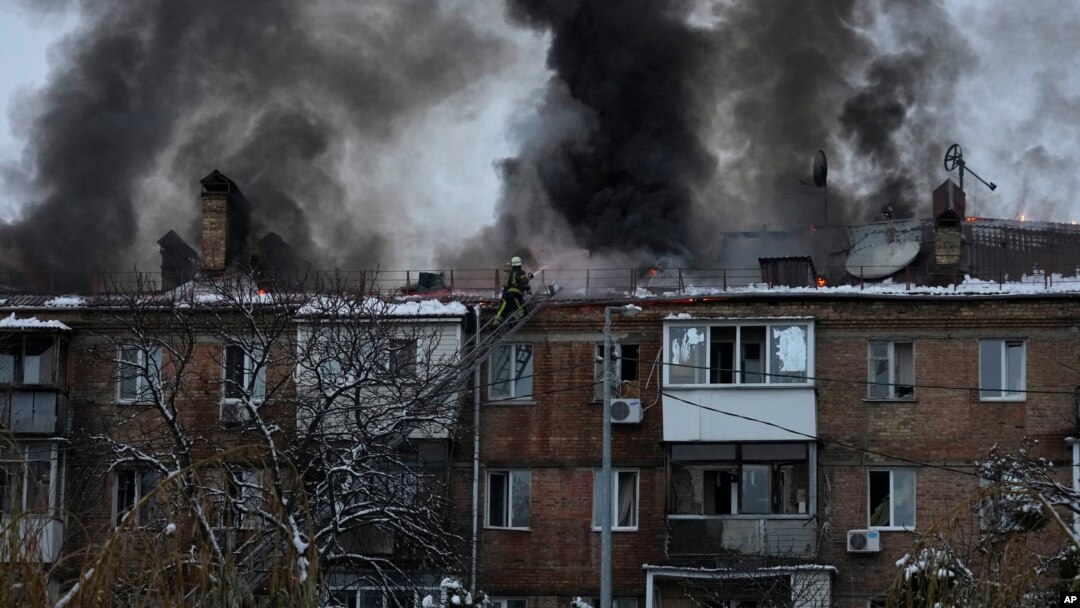 Ukrainian State Emergency Service firefighters work to extinguish a fire at the scene of a Russian shelling in the town of Vyshgorod outside of the capital Kyiv, Ukraine, Nov. 23, 2022. 