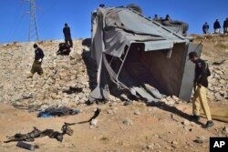 FILE - Pakistani security officials inspect a damaged truck at the site of suicide bombing on the outskirts of Quetta, Pakistan, Nov. 30, 2022. The outlawed Tehrik-i-Taliban Pakistan, also known as the Pakistani Taliban, claimed responsibility for the attack.