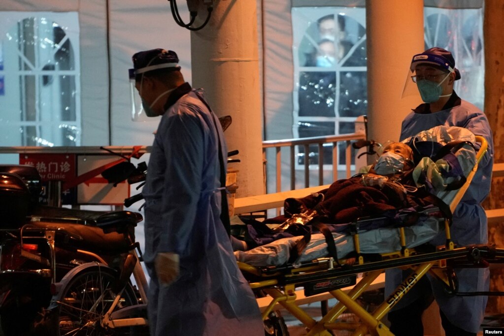 上海医护人员在运送一名病人进入医院的发热门诊。（2022年12月19日）(photo:VOA)