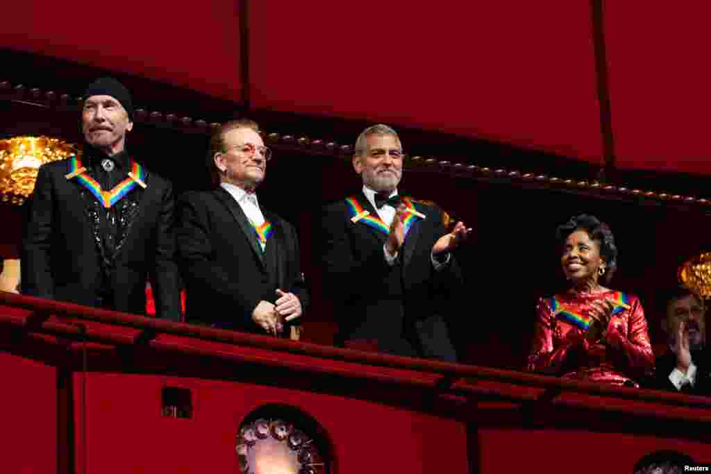 Kennedy Center honorees, from left, U2 band members The Edge, Bono, actor and filmmaker George Clooney, and Cuban-born American composer, conductor and educator Tania Leon, attend the Kennedy Center honorees gala in Washington, D.C., Dec. 4, 2022. 