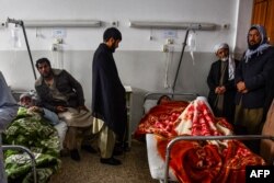 Kerabat mengunjungi keluarganya yang menjadi korban bom pinggir jalan yang menghantam sebuah bus yang membawa karyawan perusahaan minyak di Mazar-i-Sharif, 6 Desember 2022.(AFP)