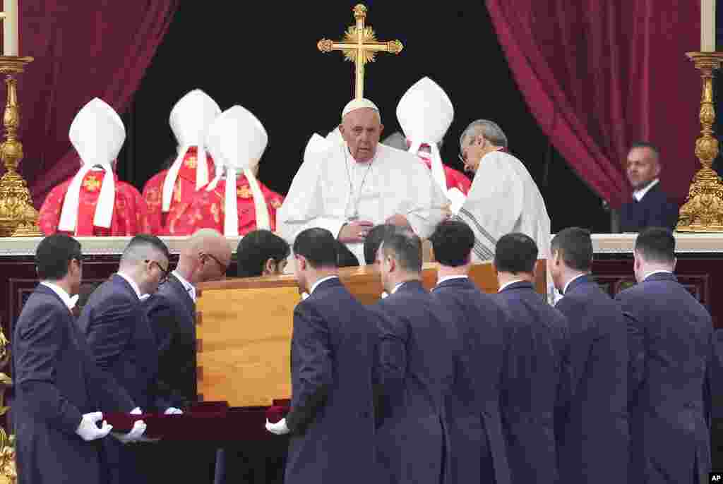 Pope Francis looks on as the coffin of late Pope Emeritus Benedict XVI is carried for a funeral Mass in St. Perter&#39;s Square at the Vatican, Jan. 5, 2023.