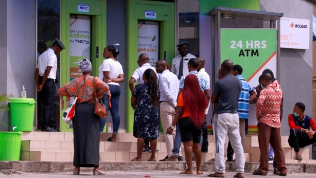 FILE - People queue at ATMs in Abuja, Nigeria, March 30, 2020.