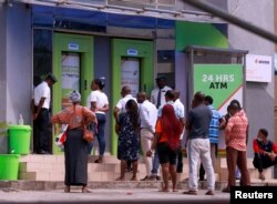 FILE - People queue at ATMs in Abuja, Nigeria, March 30, 2020.