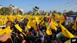 Palestinian Fatah supporters chant slogans and wave the movement's flags during a rally marking the 58th anniversary of Fatah movement foundation in Gaza City, Dec. 31, 2022. 