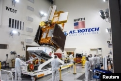The Surface Water and Ocean Topography (SWOT) radar satellite spacecraft is moved into a transport container inside the Astrotech facility at Vandenberg Space Force Base in California, U.S. November 18, 2022. (USSF/Chris Okula/Handout via REUTERS)