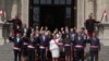 Peruvian President Dina Boluarte, center front, and newly named cabinet members wave as after their swearing-in ceremony on the steps of the government palace in Lima, Peru, Dec. 10, 2022. Boluarte asked each minister to pledge to work "without committing acts of corruption." 