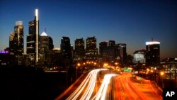 FILE - In this image made with a long exposure, motor vehicles move along Interstate 76 ahead of the Thanksgiving Day holiday in Philadelphia, Nov. 23, 2022. 