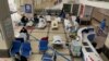 FILE - A man stands in front of a cordoned-off area, where Covid-19 coronavirus patients lie on hospital beds, in the lobby of the Chongqing No. 5 People's Hospital in China's southwestern city of Chongqing, Dec. 23, 2022.