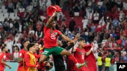 Portugal's Otavio celebrates with team mates after the World Cup quarterfinal soccer match between Morocco and Portugal, at Al Thumama Stadium in Doha, Qatar, Saturday, Dec. 10, 2022. 