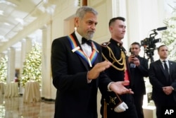 Actor, director and producer George Clooney arrives to attend the Kennedy Center honorees reception at the White House in Washington, Sunday, Dec. 4, 2022. (AP Photo/Manuel Balce Ceneta)