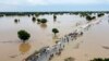 People walk through floodwaters after heavy rainfall in Hadeja, Nigeria, on Sept 19, 2022. 