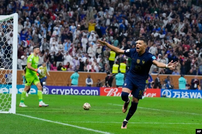 France's Kylian Mbappe celebrates after scoring his third goal against Argentina during the World Cup final soccer match at the Lusail Stadium in Lusail, Qatar, Sunday, Dec. 18, 2022. (AP Photo/Natacha Pisarenko)