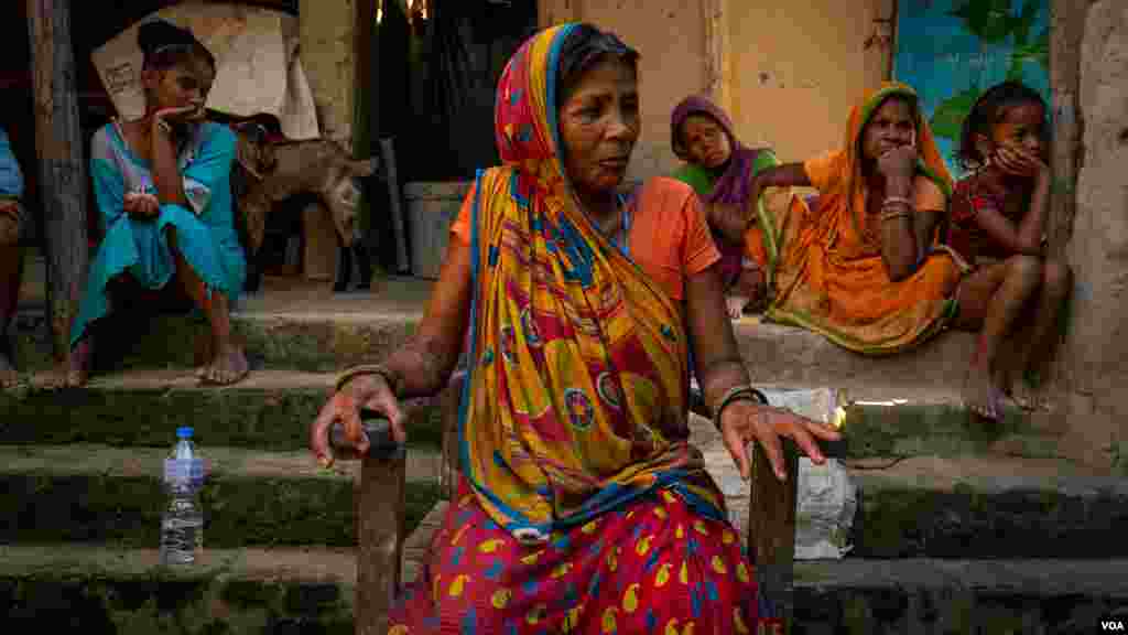 Sukhi Mukhiya, 52, says her son, Jit Narayan, 30, was promised work as a painter, but, in the end, worked and died as a bricklayer under the strong Qatar sun. "He died of exhaustion," she said in the Dhanusha district of Nepal, August 2022 (Yan Boechat/VO