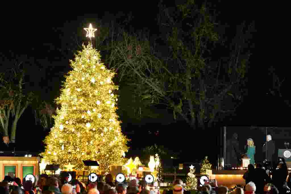 President Joe Biden, first lady Jill Biden, and LL Cool J react after lighting the National Christmas Tree on the Ellipse, near the White House in Washington, Nov. 30, 2022.