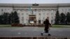 A woman walks in front of regional administration building at the city center of Kherson, Ukraine, Dec. 10, 2022. 