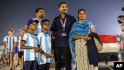 Smitha Issac, right, originally from India and living in Qatar, heads with her family to Stadium 974 in Doha to attend the World Cup match between Poland and Argentina, Nov. 30, 2022.