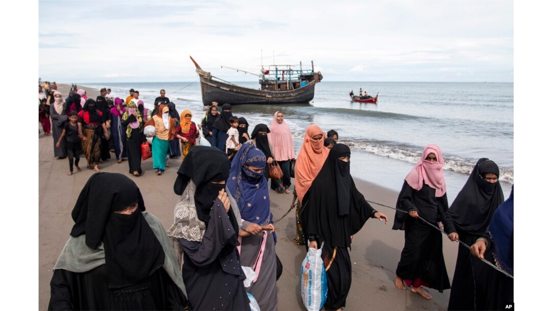 Warga etnis Rohingya berjalan menuju tempat penampungan sementara setelah mereka mendarat di perahu kayu mereka di Aceh Utara, 16 November 2022. (Foto: AP)