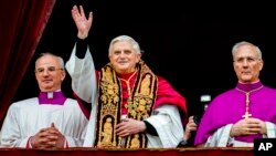 FILE - Pope Benedict XVI, flanked by Monsignor Francesco Camaldo, left, and Bishop Piero Marini, greets the crowd from the central balcony of St. Peter's Basilica at the Vatican soon after his election on April 19, 2005. 