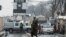A member of Taliban security force stands guard on a blocked road after a suicide blast near Afghanistan's foreign ministry at the Zanbaq Square in Kabul on Jan.11, 2023. 