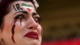An Iranian woman, name not given, breaks into tears after a member of security seized her flag reading "Woman Life Freedom" before the start of the World Cup group B soccer match between Wales and Iran, at the Ahmad Bin Ali Stadium in Al Rayyan, Qatar.