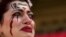 An Iranian woman, name not given, breaks into tears after a member of security seized her flag reading "Woman Life Freedom" before the start of the World Cup group B soccer match between Wales and Iran, at the Ahmad Bin Ali Stadium in Al Rayyan, Qatar.