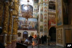 Officials inspect the Assumption Cathedral in the Pechersk Lavra monastic complex in Kyiv, Ukraine, Nov. 22, 2022. Ukrainian counterintelligence and police officers searched the site after a priest spoke favorably about Russia – Ukraine's invader – during a service.