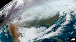 This satellite image made available by NOAA shows weather systems across North America on Dec. 23, 2022, at 10:56 a.m. EST.