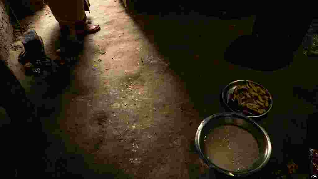 Aslan Devi Yadav, 41, prepares lunch for her four kids. With little money, the family eats mostly rice and some vegetables in the Dhanusha district of Nepal, August 2022 (Yan Boechat/VOA) 