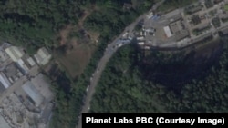 A satellite image from Dec 26, 2022, shows vehicles gathering outside a funeral home in Panyu District, Guangzhou. 