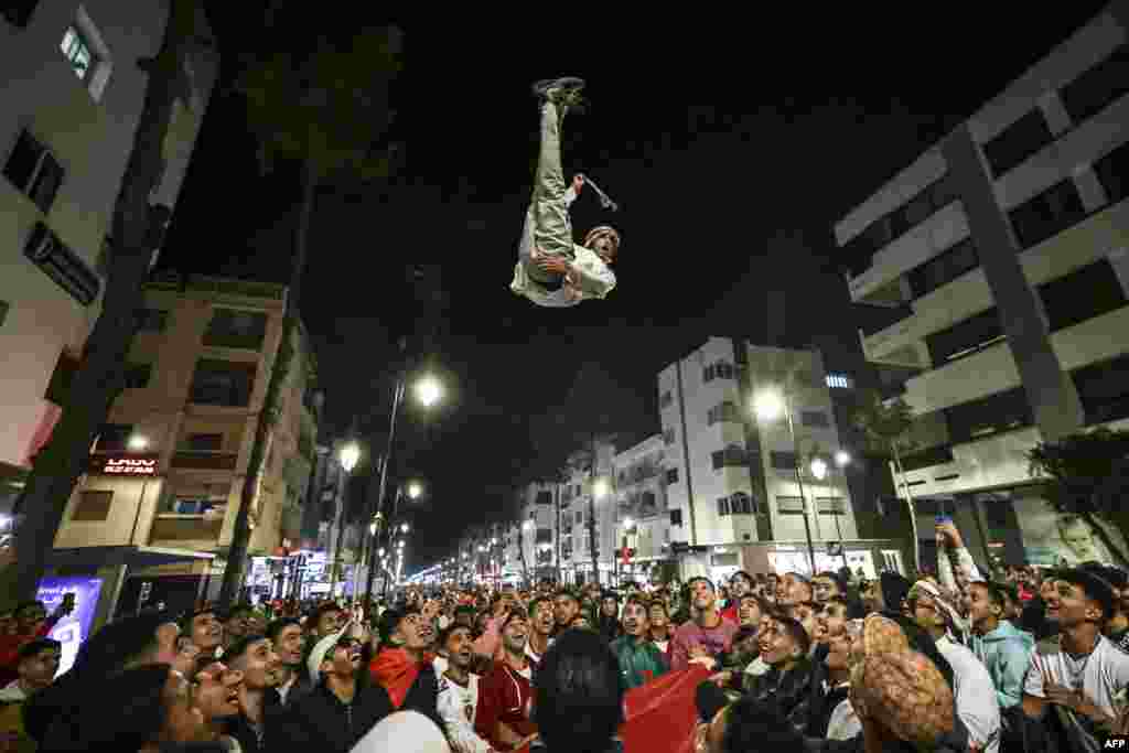 Morocco's supporters celebrate after their country's win of the Qatar 2022 World Cup football match between Morocco and Portugal, in the capital Rabat, Dec. 10, 2022. 