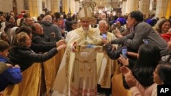 The acting Latin Patriarch of Jerusalem Pierbattista Pizzaballa leads a Christmas midnight Mass at the Church of the Nativity compound in the West Bank town of Bethlehem.