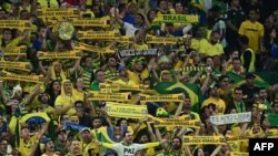 Supporters of Brazil listen to the national anthem ahead of the Qatar 2022 World Cup quarterfinal football match between Croatia and Brazil at Education City Stadium in Al-Rayyan, west of Doha, on December 9, 2022.