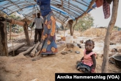 One-year-old Awa Ba plays close to a gold mining pit in Senegal's Kedougou region Nov. 16, 2022.